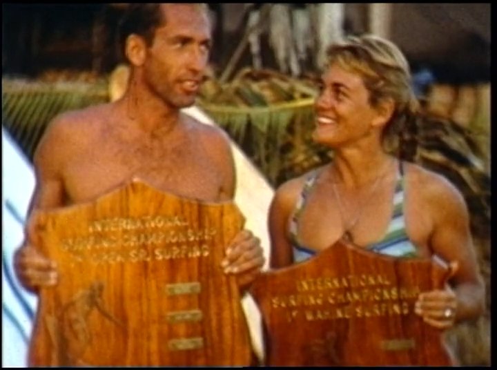 Athletes hold wooden plaques during an international surfing championship awards ceremony before transitioning to scenes of competitive rowing on the water.