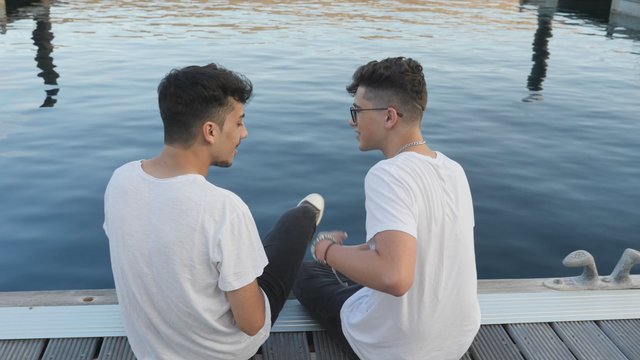 Gay couple hugging near the lake 