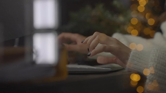 A woman’s hands typing on a keyboard