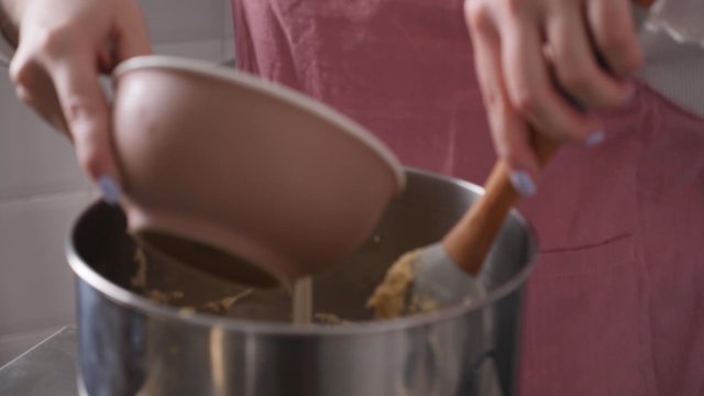 Pouring milk into the dough