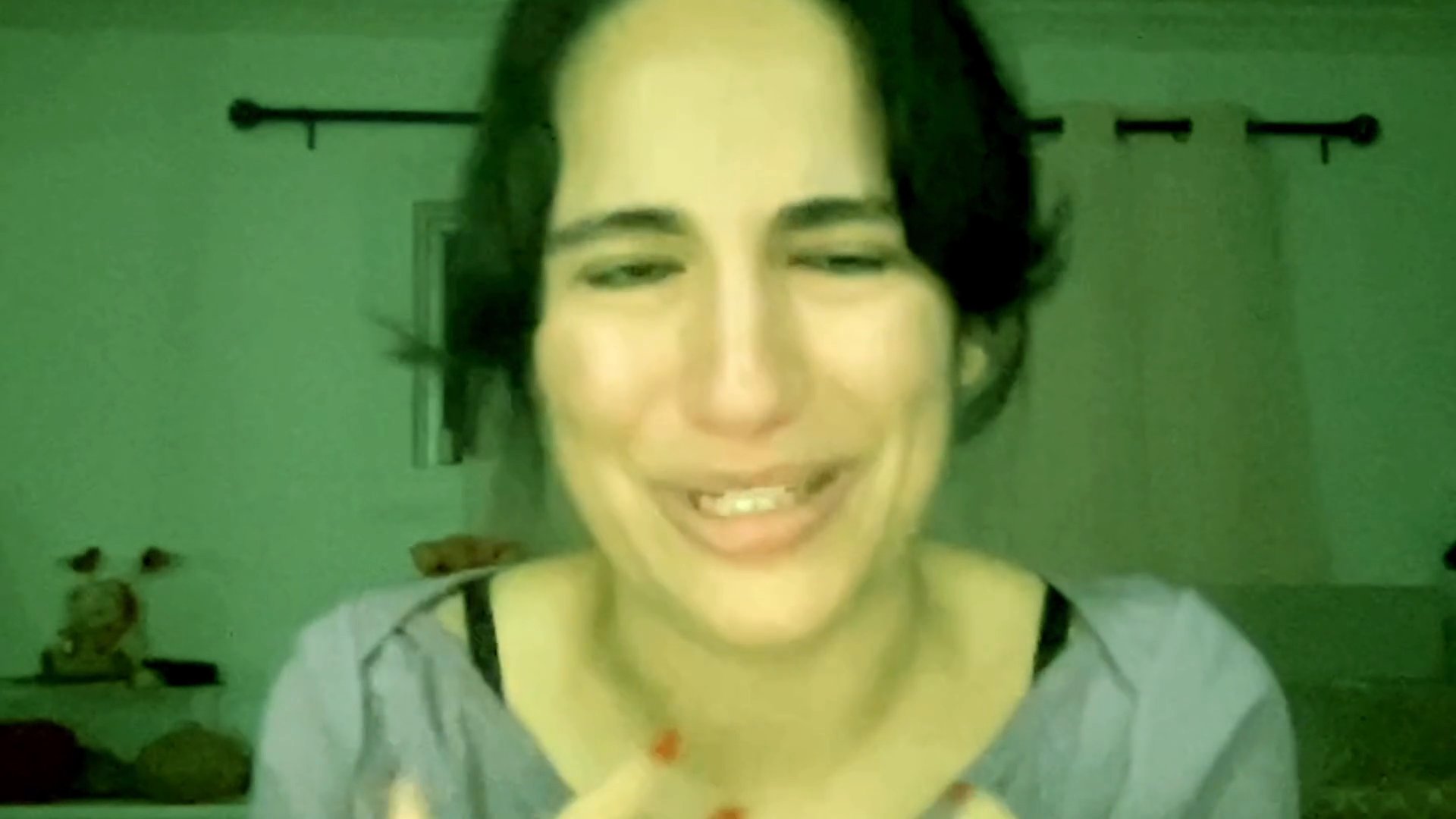 A woman speaks directly to the camera with visible signs of distress, sorrow, and emotional pain.