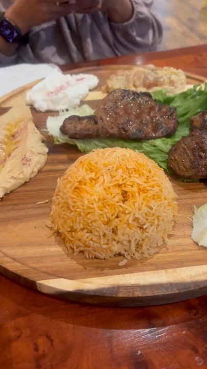 Sanabreh - Spice basmati rice, hummus, eggplant, garlic mayo, and the stars  of the meal, grilled steak and lamb chops. - Mediterranean Near Me - Houston, Texas