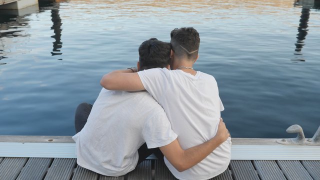 Gay couple hugging and smiling