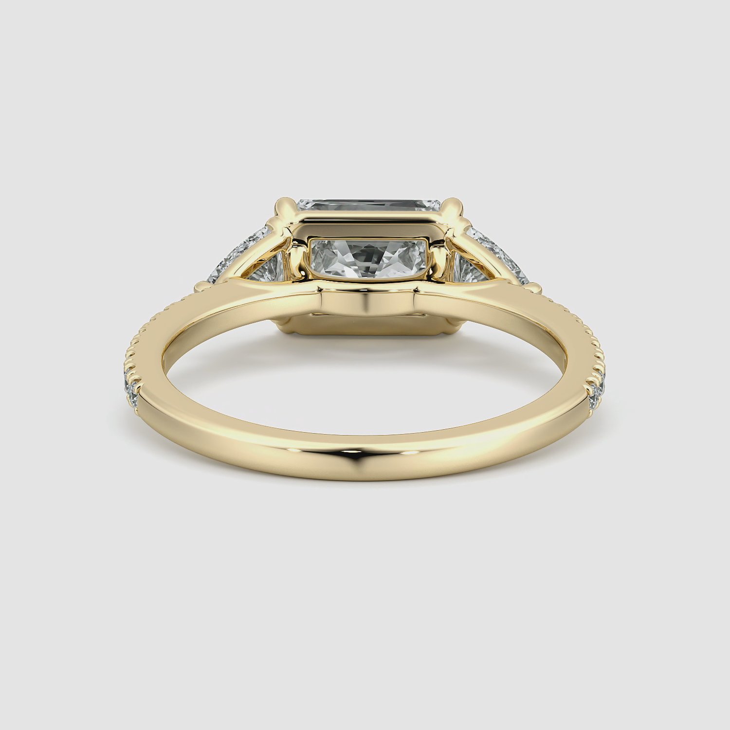 The Three Stone | Radiant | 18k | Yellow Gold | bandAccent: Pavé | diamondOrientation: horizontal | sideStoneCarat: 0.25ct | sideStoneShape: Trillion | caratWeight: other