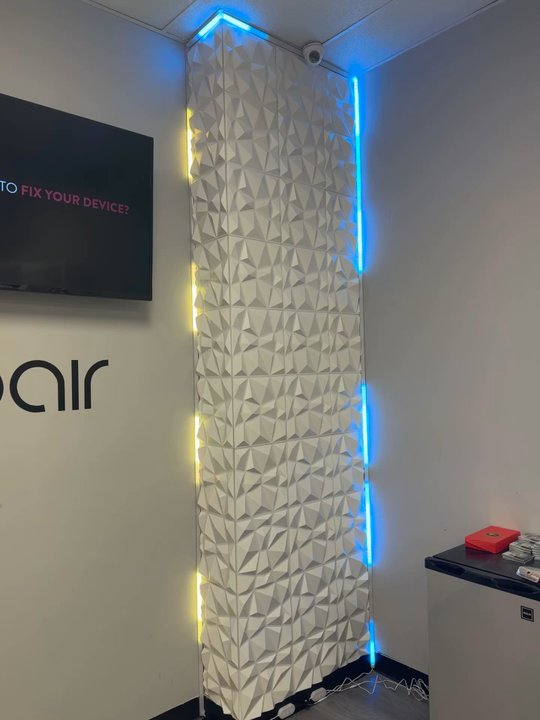 LevRemodeling - Corner wall installed with 3D wall panels and lined up with LED lights in aluminum covers. - General Contractors Near Me