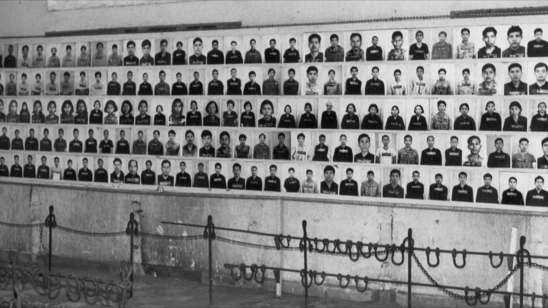 Historical identification photographs of Khmer Rouge victims transition into a memorial display at the Tuol Sleng Genocide Museum in Cambodia.