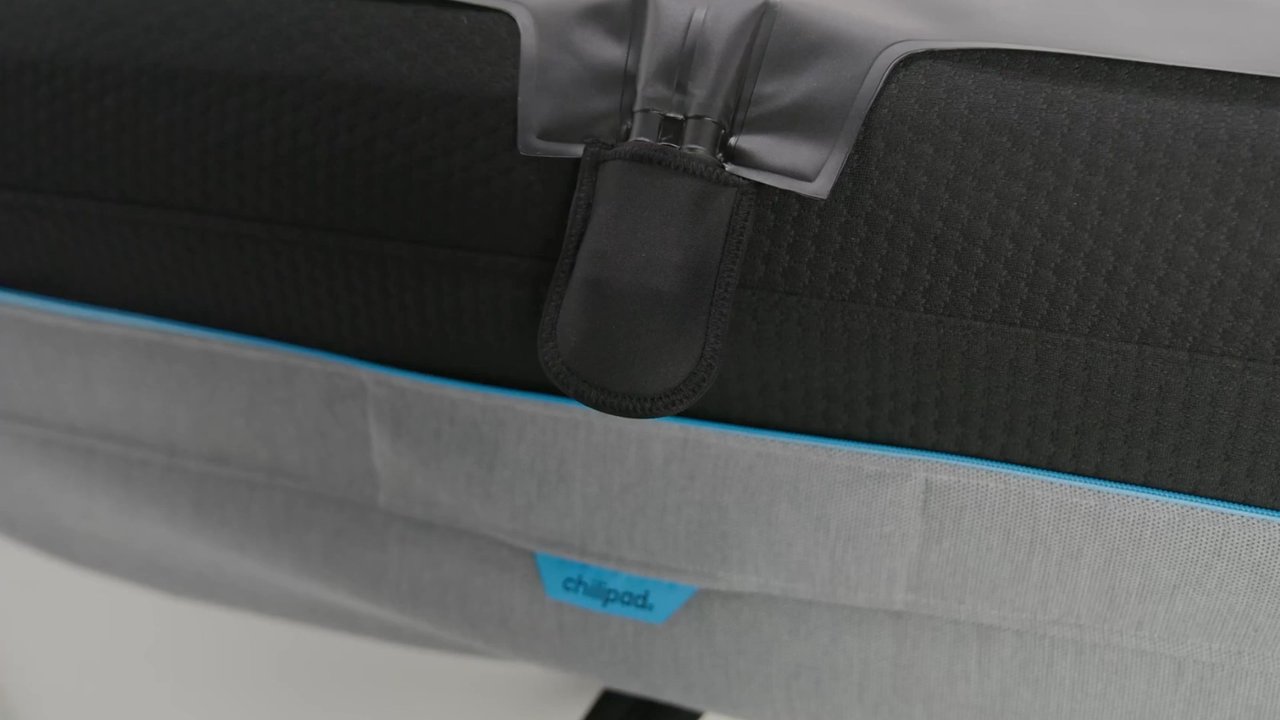 Sliding hose through Chilipad pad opening, attaching hydrolayer, and zipping top and bottom layers closed
