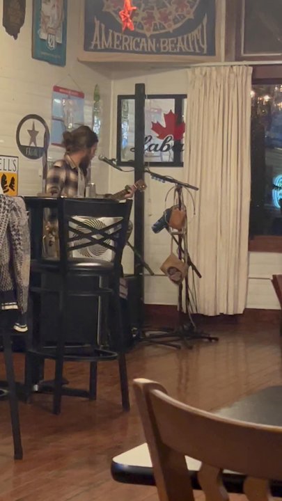 Eclipse Company Store - Micah singing bluegrass music on his cigar box - Bars Near Me - The Plains, Ohio