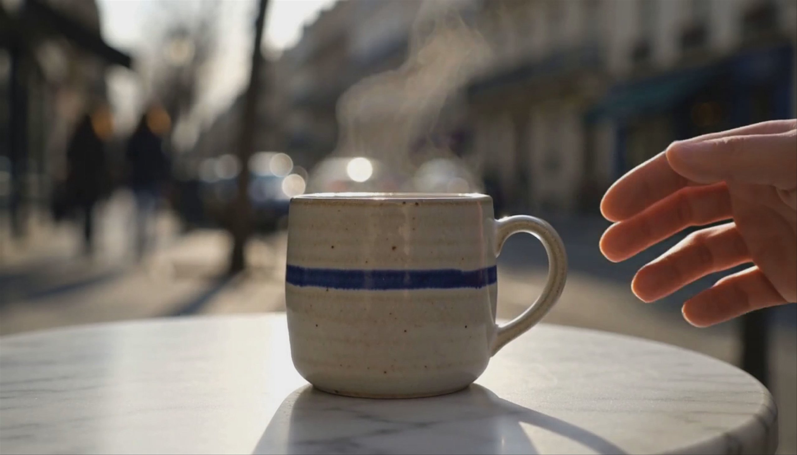 The same mug on a marble café table outdoors, a scene it was never photographed in