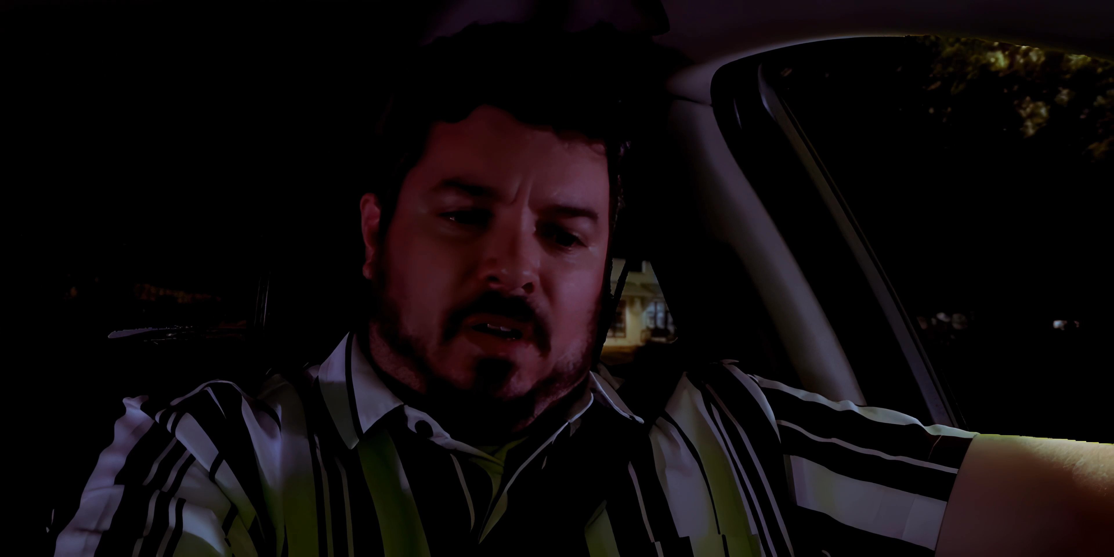 A man sitting in a parked car at night receives an incoming phone call from a contact named Kate and hesitates to answer.