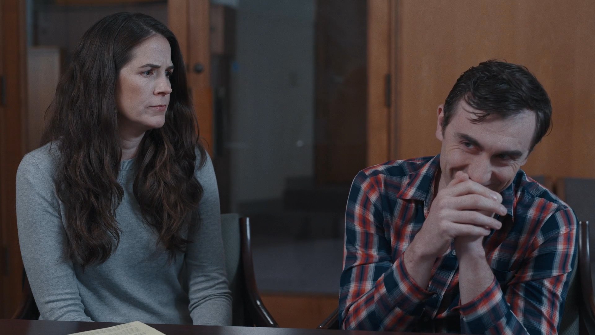 A medical professional conducts a consultation with a couple, who transition from a state of concern to active, positive engagement during the discussion.