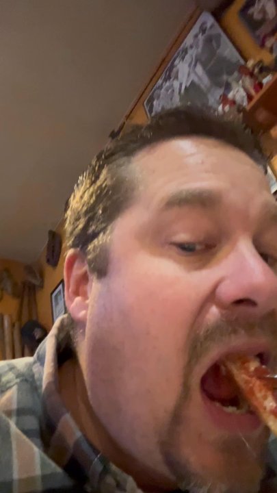 Roscoe's Pizza - Eating a slice of - Pizza Near Me - Cedar Rapids, Iowa