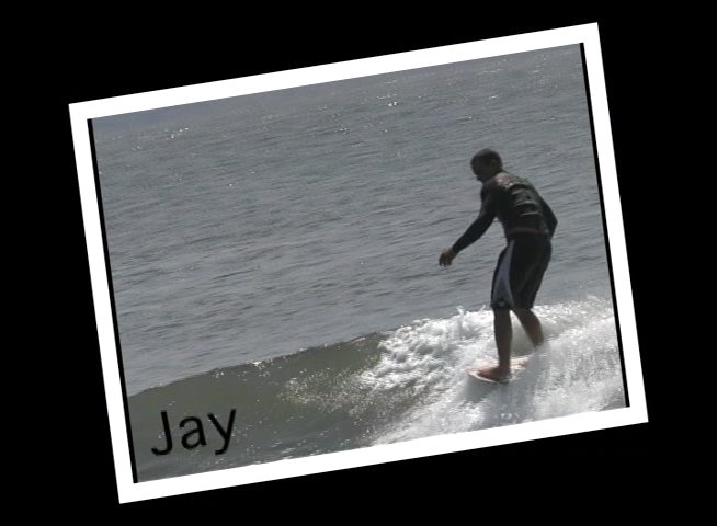 Diverse surfers ride waves in the ocean while wearing wetsuits. The footage highlights various individuals navigating coastal surf conditions.