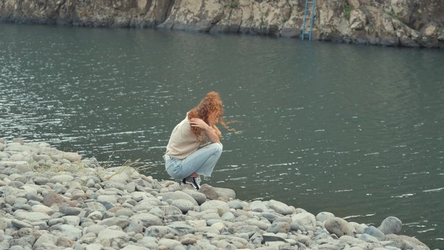 A despondent girl hugging herself while crouched