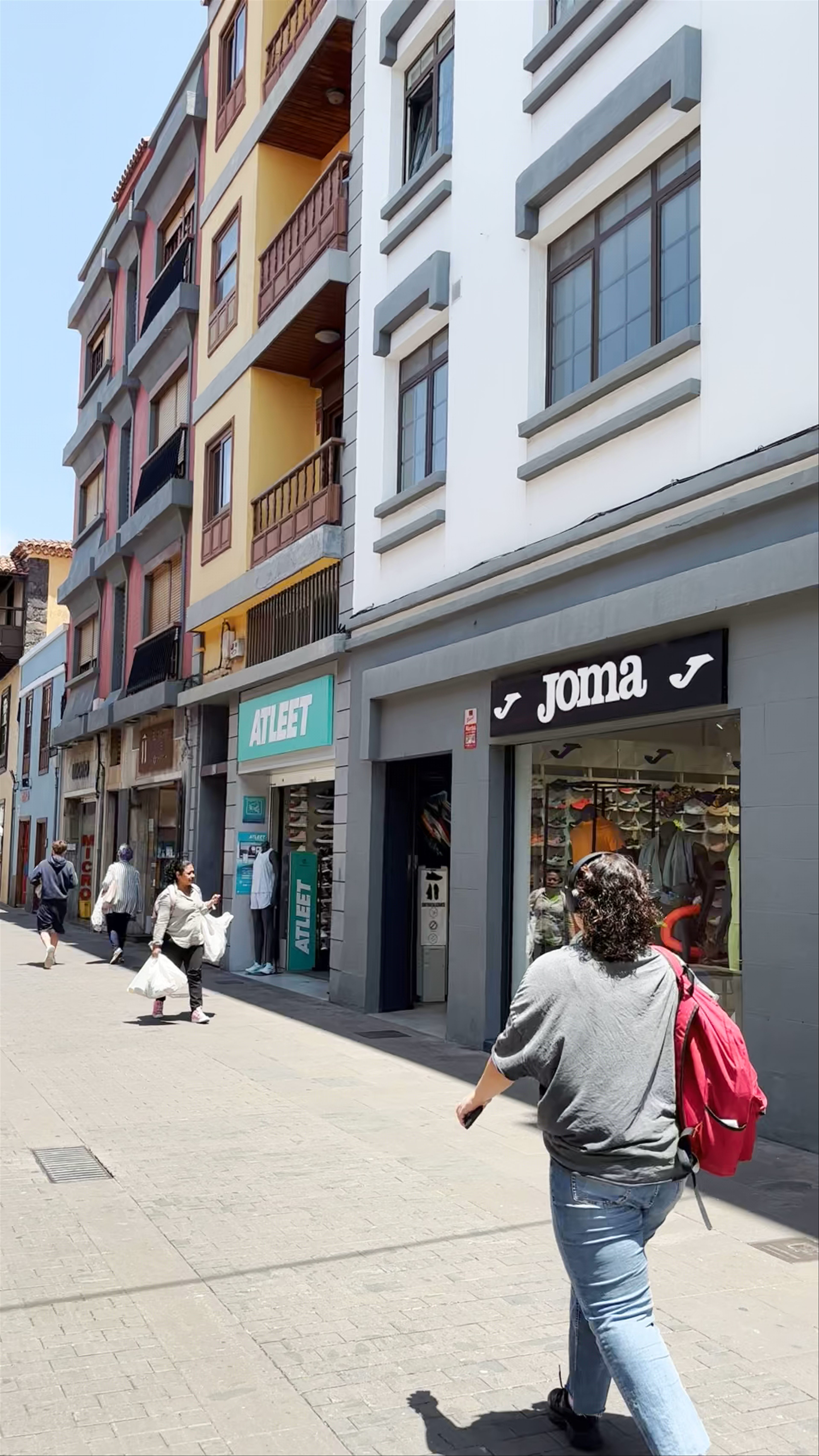Sunlit Streets and Local Shopping in San Cristóbal de La Laguna, Spain