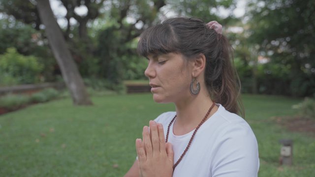 A woman practicing yoga outdoors