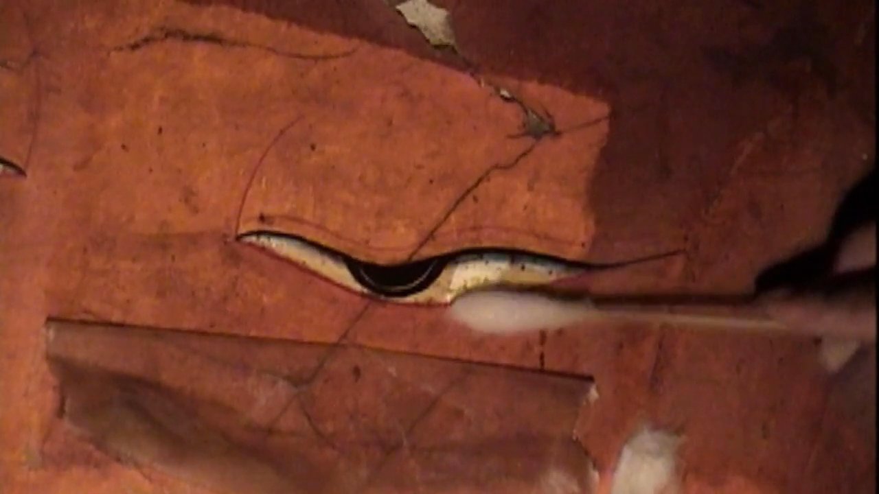 An expert team performs delicate restoration work on ancient wall paintings within a monastery. The process involves meticulous cleaning and color touch-ups to preserve the historical integrity of the artwork.