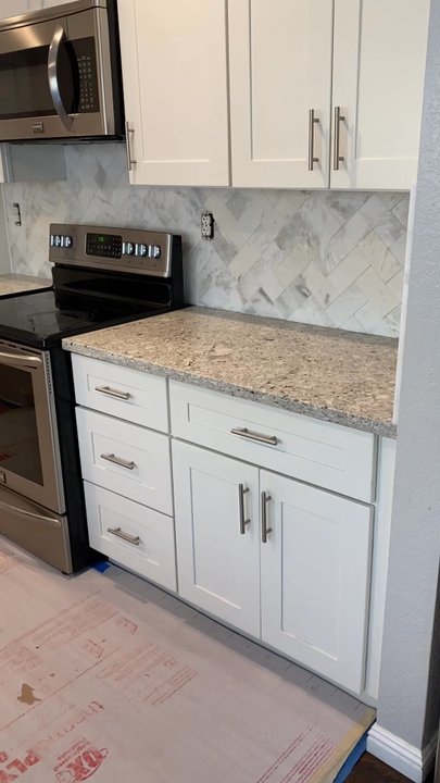 Andrew's Tile - Beautiful work here - Carrera Marble in Herringbone Pattern (ps this is labor intensive) This video was taken before the grout was applied - Tiling Near Me