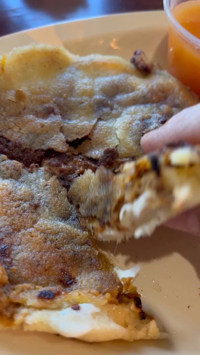 El Guanaco - Look at that cheese pull on my pork, bean and cheese pupusa! - Salvadoran Near Me - St. Louis, Missouri