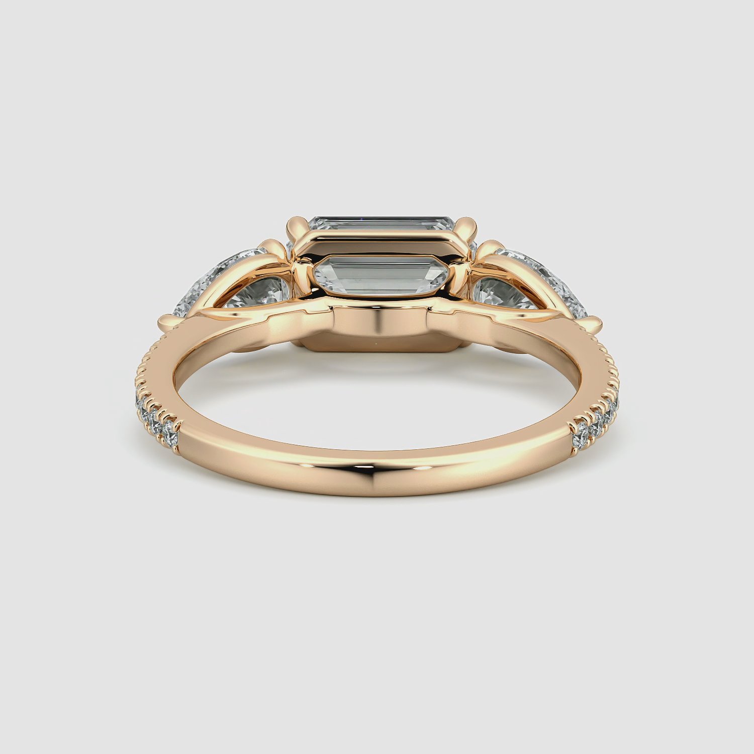 The Three Stone | Emerald | 14k | Rose Gold | bandAccent: Pavé | diamondOrientation: horizontal | sideStoneCarat: 0.50ct | sideStoneShape: Pear | caratWeight: other