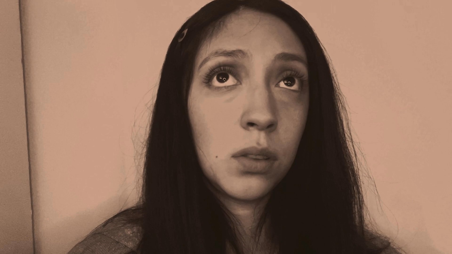 A woman engages in deep thought, displaying a variety of nuanced facial expressions and subtle gestures. She maintains a focused, introspective demeanor while seemingly processing internal dialogue.
