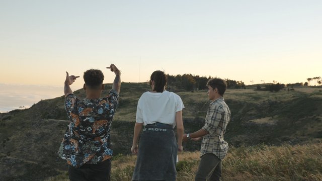 Friends putting their middle fingers up