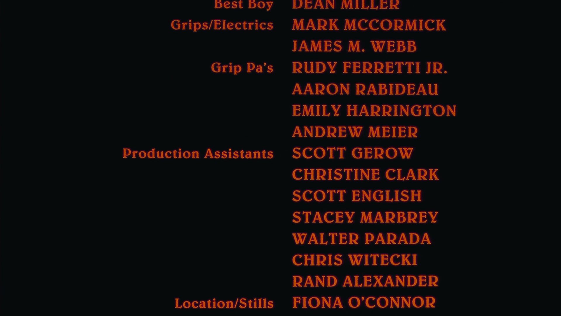 Scrolling text displays the production crew names and roles involved in the film project against a dark background.