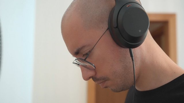 A guy reading lyrics while listening to music