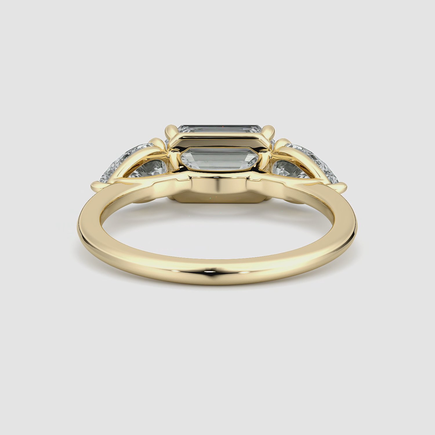 The Three Stone | Emerald | 18k | Yellow Gold | bandAccent: Plain | diamondOrientation: horizontal | sideStoneCarat: 0.50ct | sideStoneShape: Pear | caratWeight: other