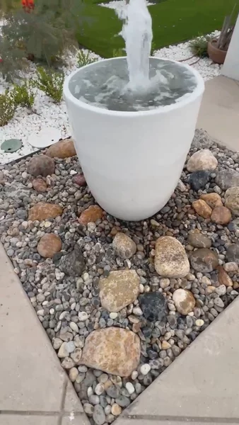 Bubbling pot water feature installed on river rock bed