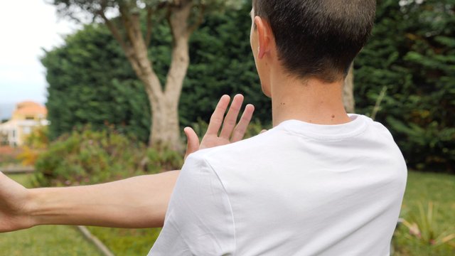 Man stretching his arms outdoors