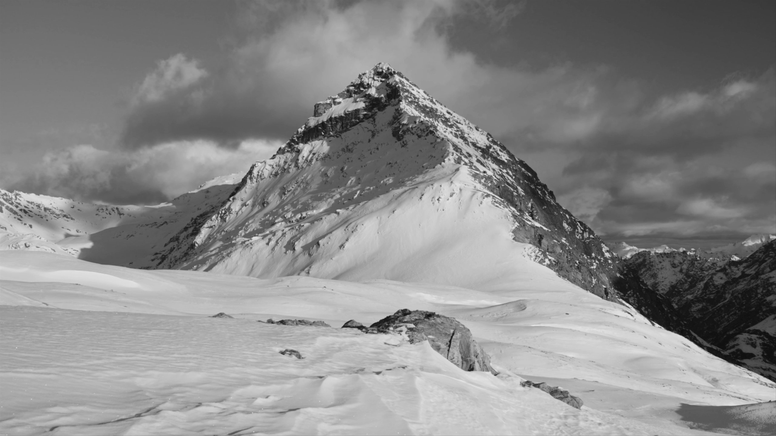 Timelapse of clouds rolling over snowy mountain peak in New Zealand