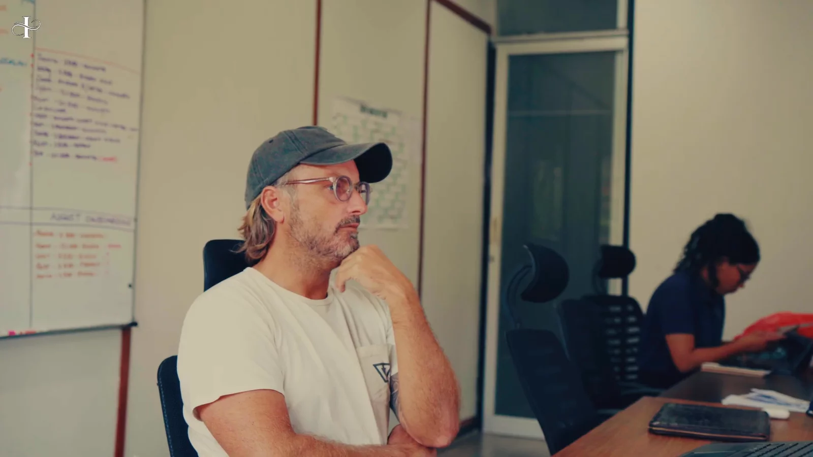 Sean Johnson in the Bali Dream Living office, whiteboards behind him