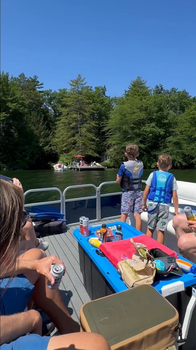 Mail Boat - Kids going up to dock to give dog treats and lollipops. - Boating Near Me