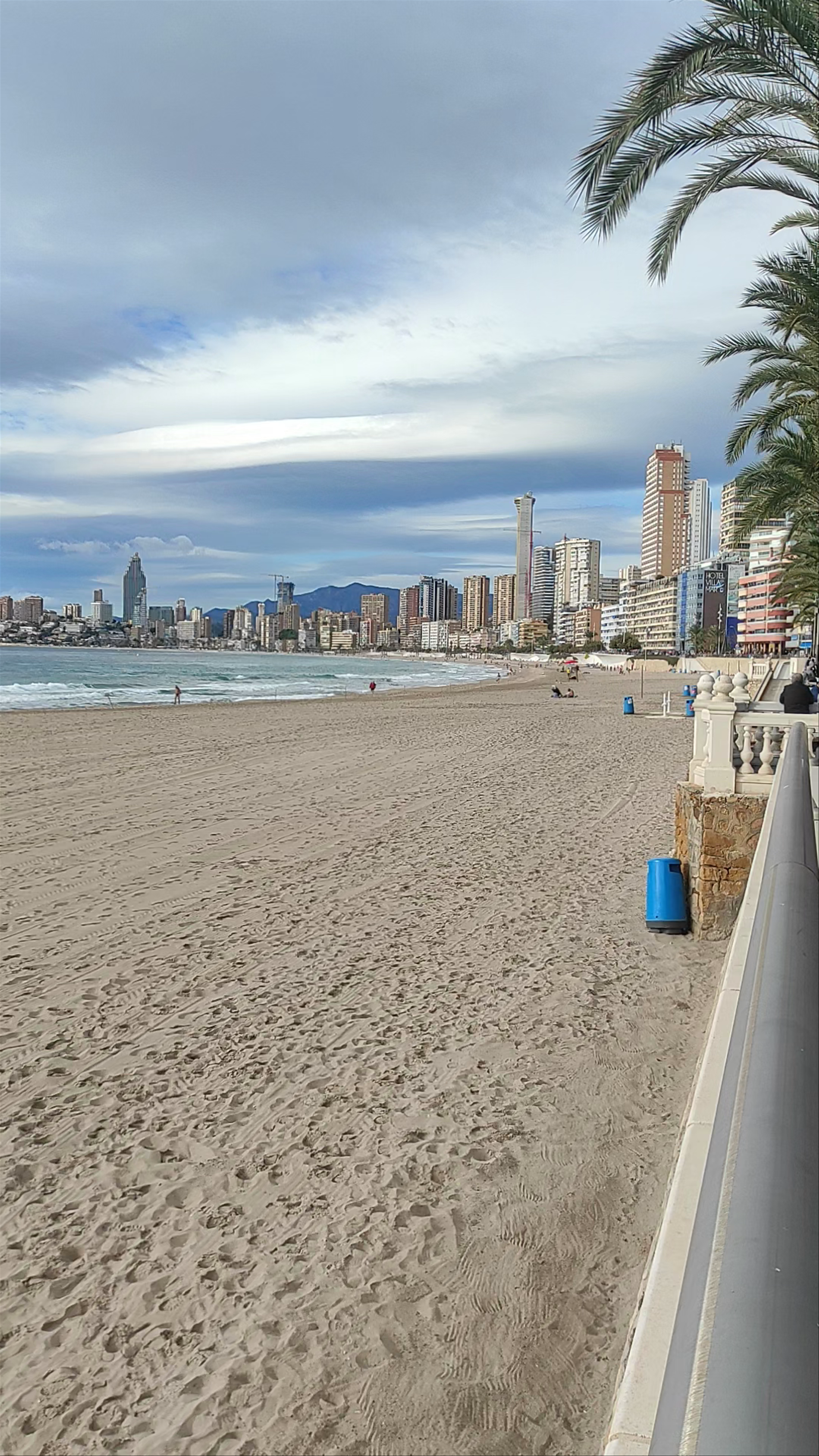 Playa de Poniente: Serene Beachscape with Urban Vibes in Benidorm, Spain