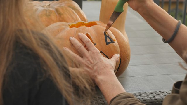 Carving an eye on a pumpkin