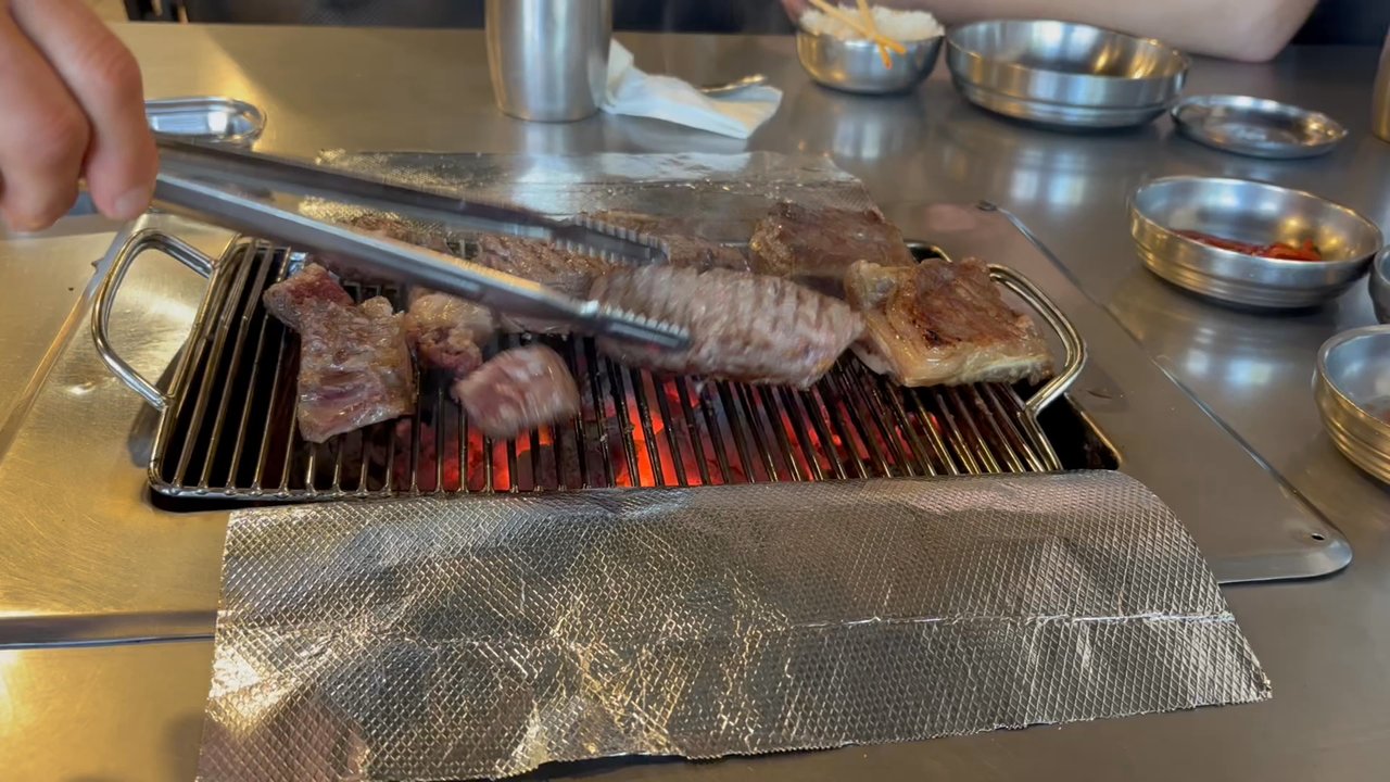 Korean Spring BBQ - Our sweet server grilling the Galbi + Wagyu Ribeye for us. Rare/medium rare by default. - Korean Near Me - Santa Clara, California