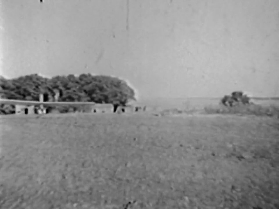 Three individuals pose before an early-model glider at an airfield before the craft executes a takeoff sequence across the grass runway.