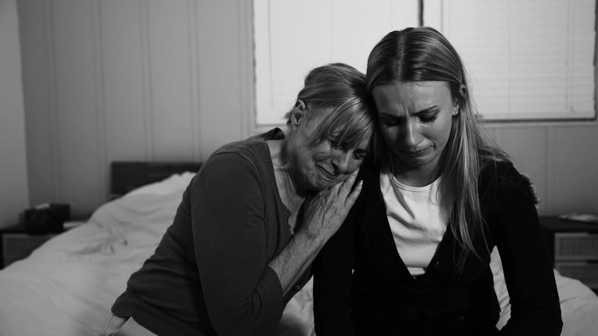 Individuals navigate varied emotional experiences, ranging from intimate moments of comfort and shared grief to casual social interactions within a home environment.
