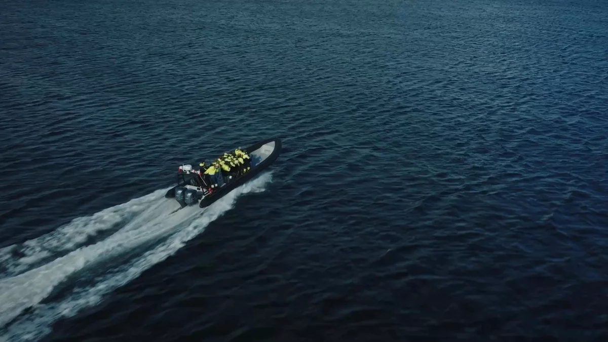 People in a rib boat and a king crab