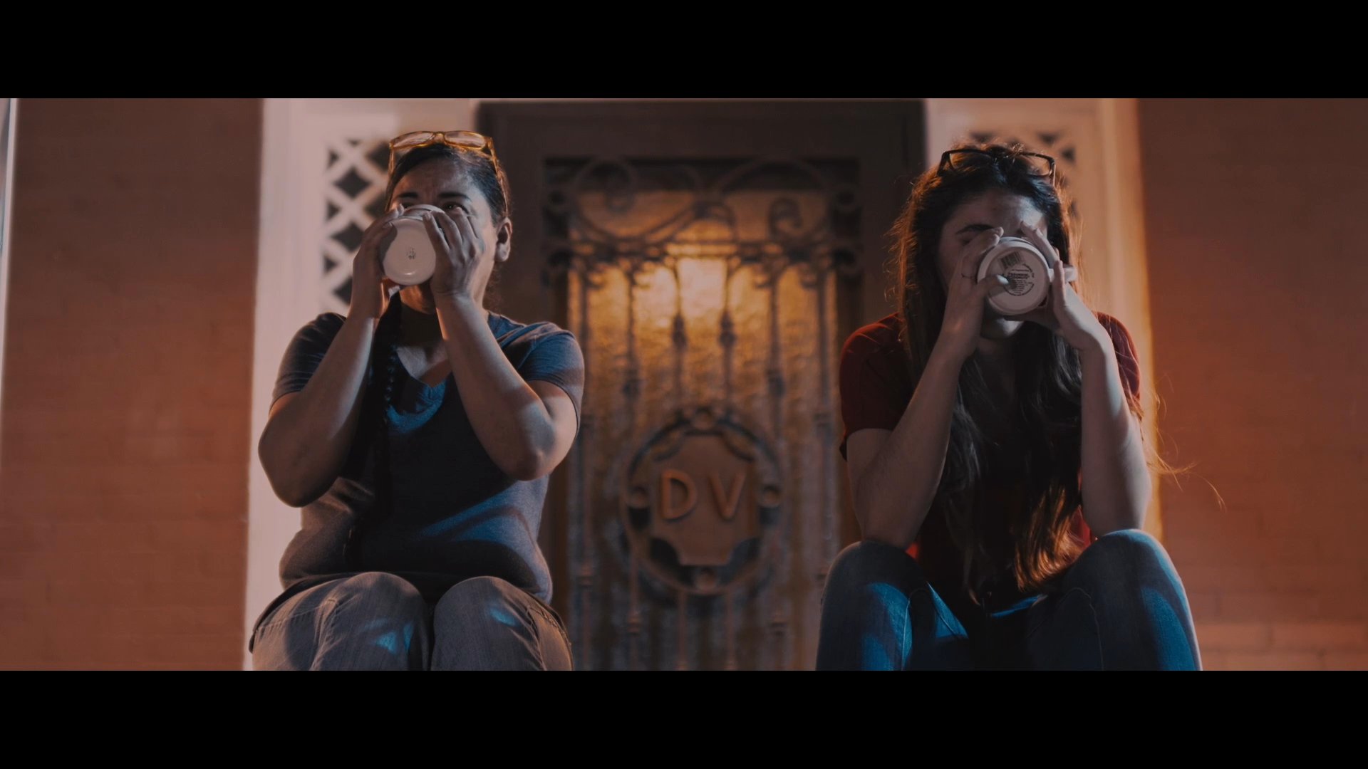A woman and her daughter engage in a poignant, heartfelt discussion while sitting together in a dimly lit, cozy environment. Their exchange centers on mutual understanding and personal emotional adjustments.
