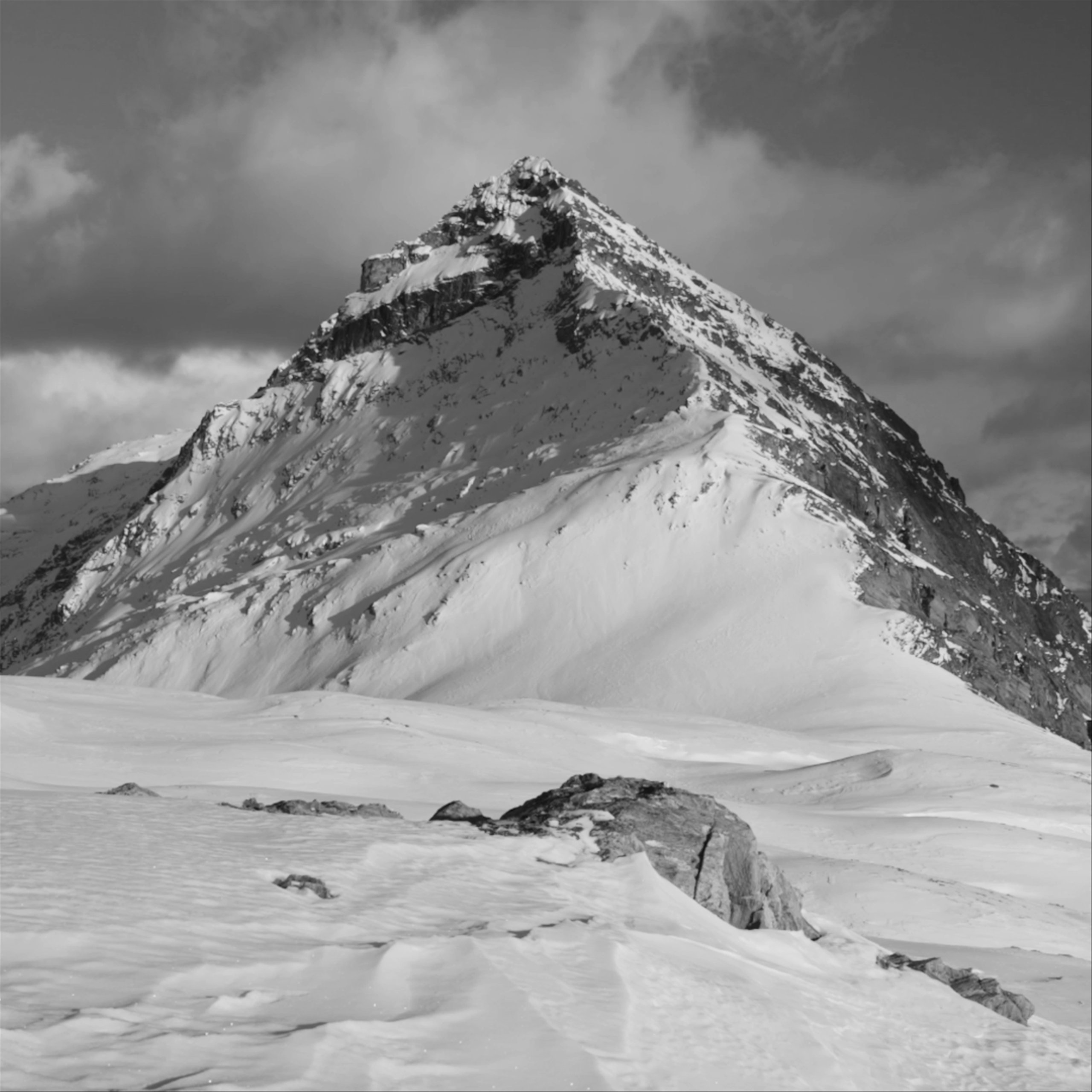 Timelapse of clouds rolling over snowy mountain peak in New Zealand