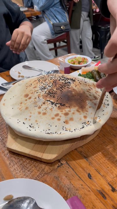 Alkofeia Restaurant - We ordered this popular dish, homemade bread covering hot roasted lamb over a plate of herbed rice with spices and raisins. Amazing. - Middle Eastern Near Me - Bayonne, New Jersey