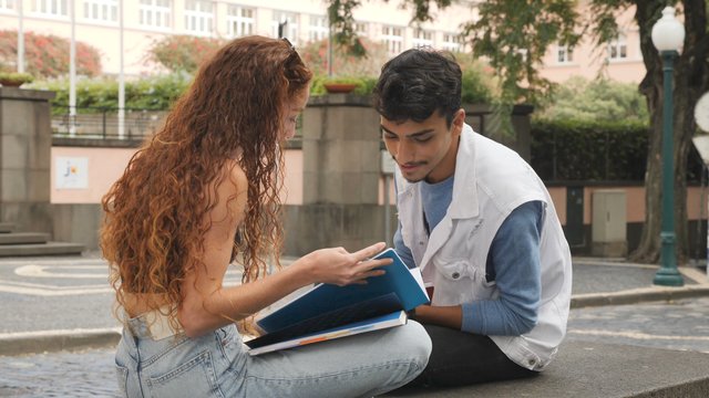 Boy and girl studying outdoors