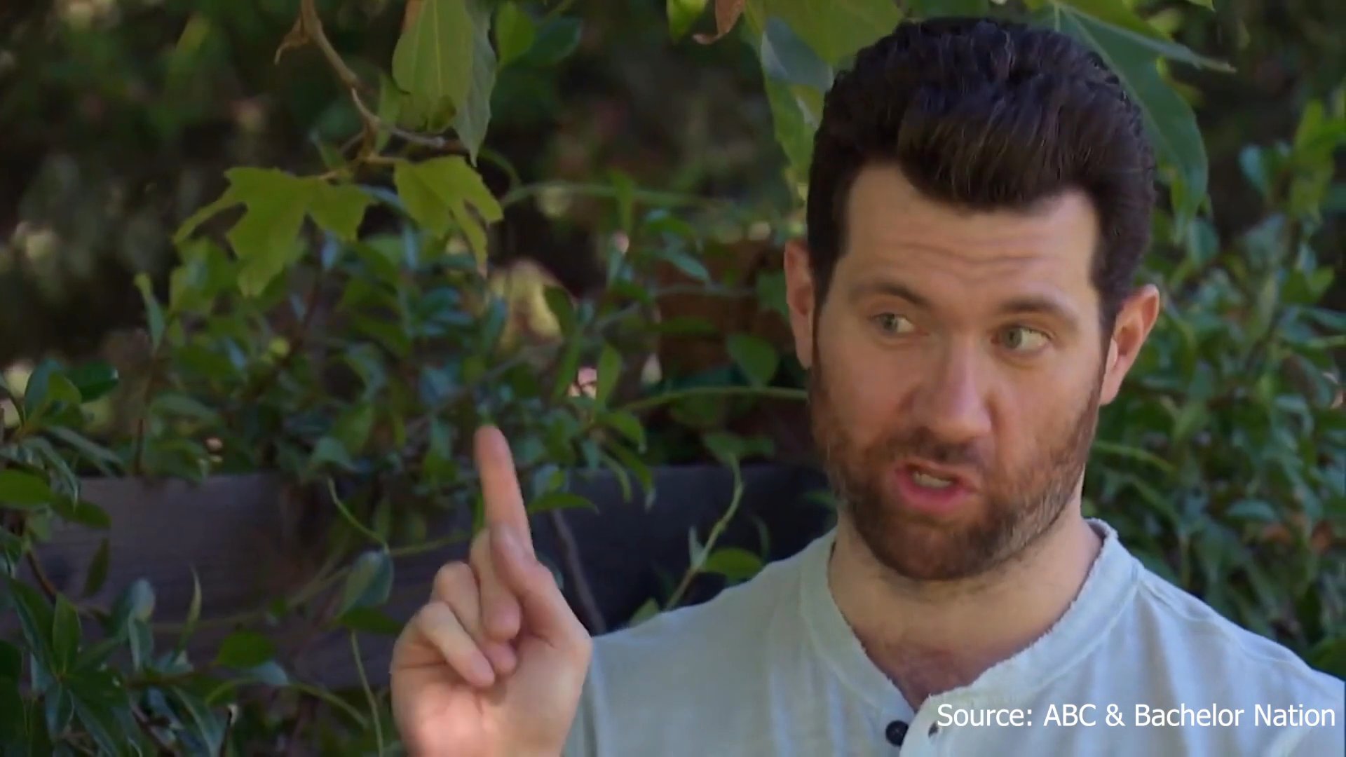 Two men engage in a candid, animated conversation during an outdoor interview, sharing emotional reflections and personal experiences.