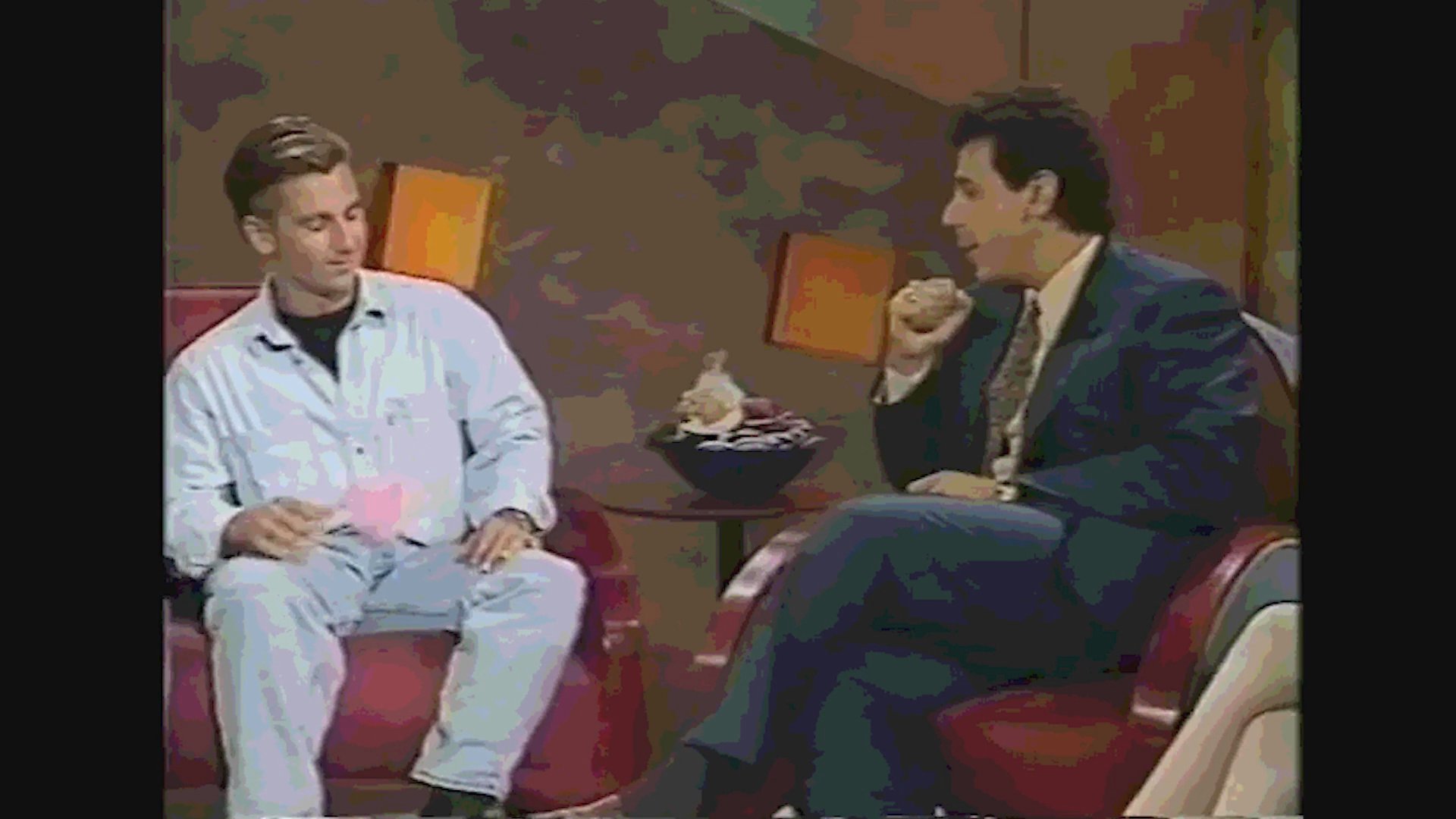 A television talk show segment shifts between displaying sensationalized newspaper headlines regarding high-profile legal cases and featuring a studio interview with guests.