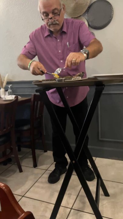 Nostalgia Greek Taverna - The owner deboning our branzino for us - Greek Near Me - Stuart, Florida